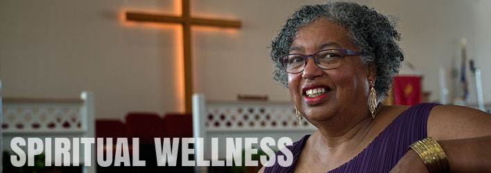 Photo of smiling woman sitting in church and the words SPIRITUAL WELLNESS written below.
