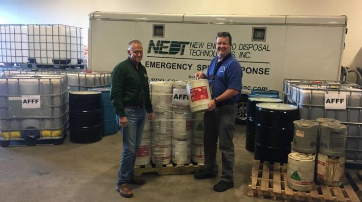 FIREFIGHTING FOAM TAKE-BACK PROGRAM… MassDEP Emergency Response Director Nick Child (right)reviews old containers of legacy firefighting foam with NEDT President Mike Robertson as part of the MassDEP Legacy Firefighting Foam Take-Back Program.