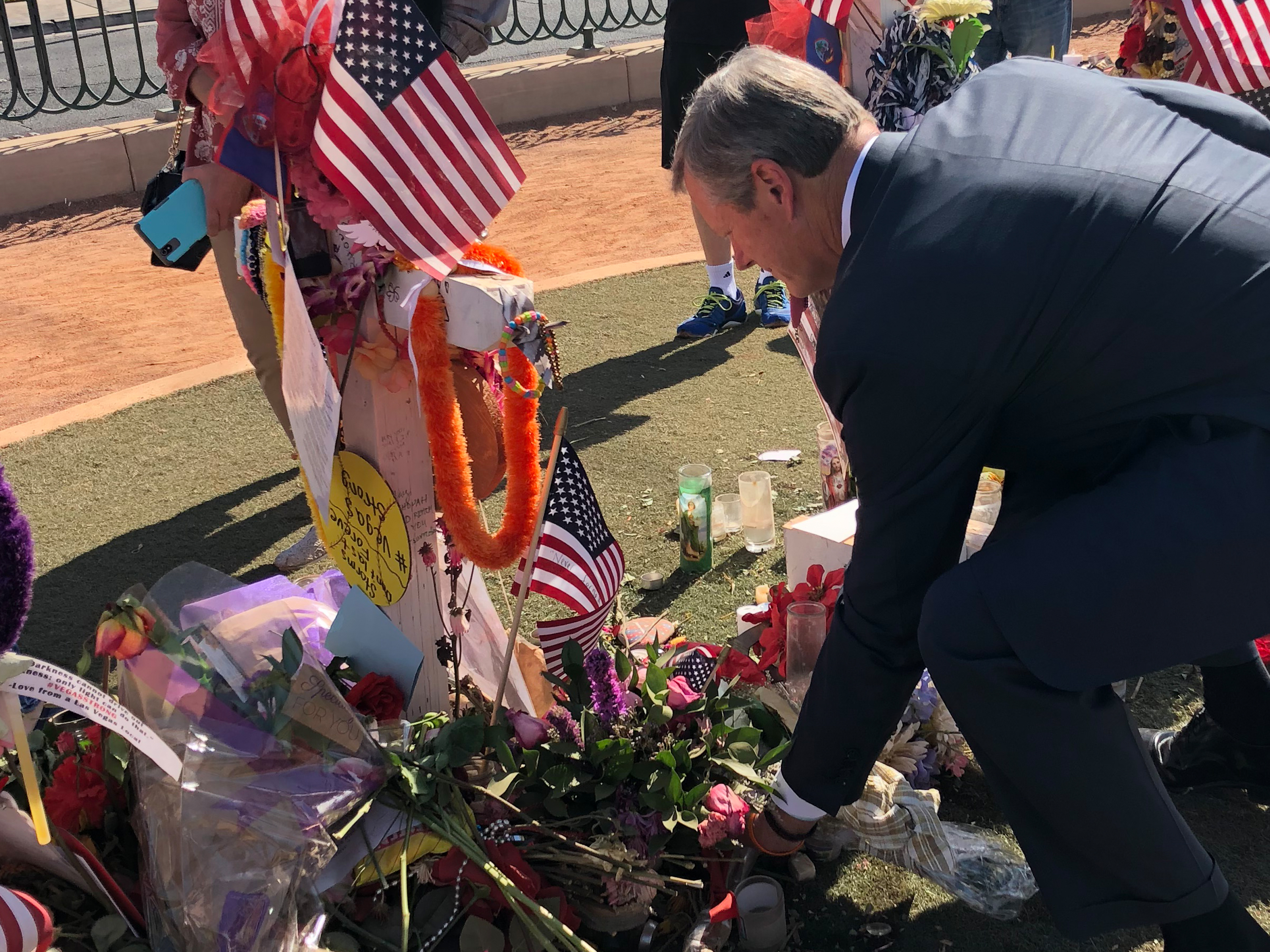 Governor Baker leaves flowers at the memorial for Tewksbury resident Rhonda LeRocque at the Las Vegas Tragedy Memorial site.