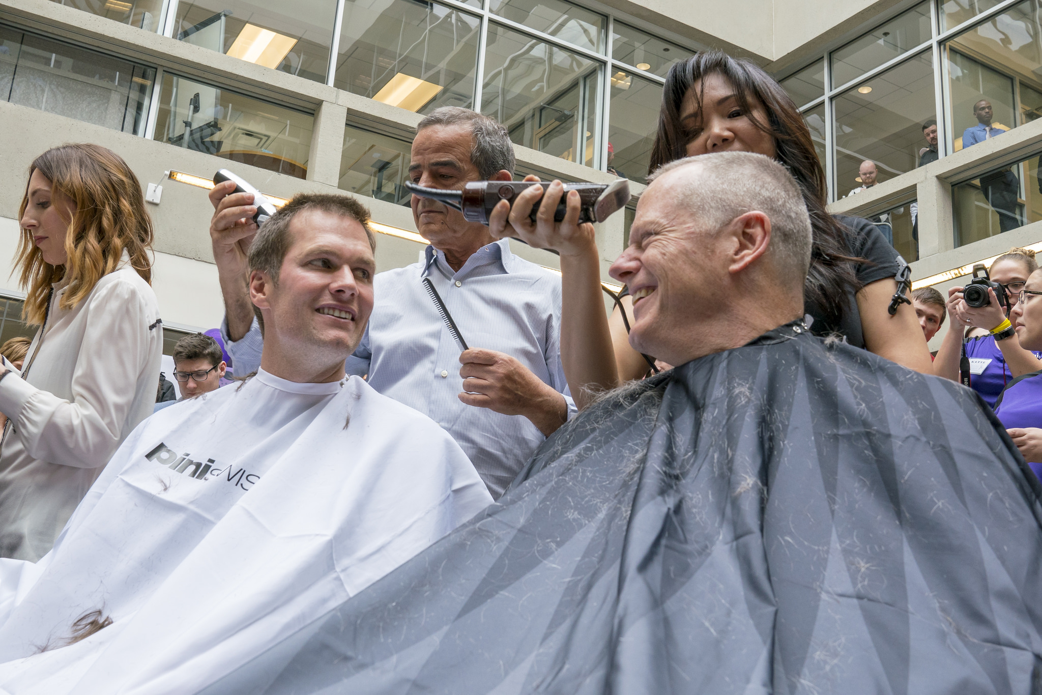 Governor Baker and Tom Brady get buzz cuts during "Saving by Shaving" event at Granite Telecom to benefit Dana-Farber.