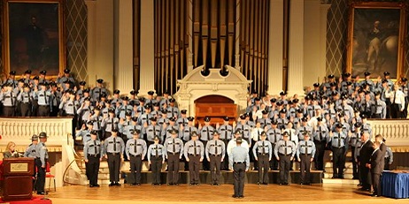 Recruits standing for graduation on stage