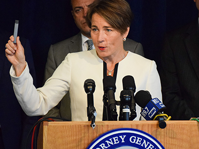 AG Healey holds a JUUL e-cigarette at a press conference.