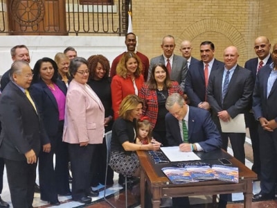 Governor Charlie Baker signs the Partnerships for Growth plan
