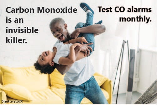 Father and son playing with the text, Carbon Monoxide is an invisible killer. Test CO alarms monthly. 