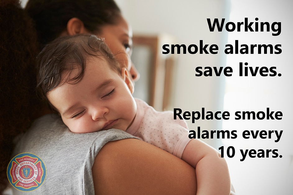 Mother holding baby with the words, "Smoke alarms save lives."