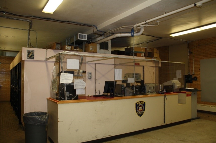 The booking desk at the Pittsfield Police Department (Berkshire County). Note: Since this photo was taken in 2011, the hardware on the desk has been updated, but other conditions still remain. (Photo courtesy of the Pittsfield Police Department)