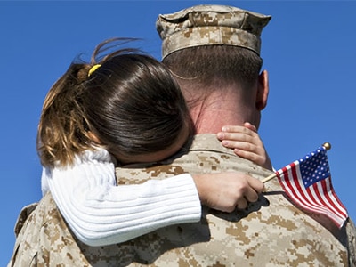 Veteran hugging daughter