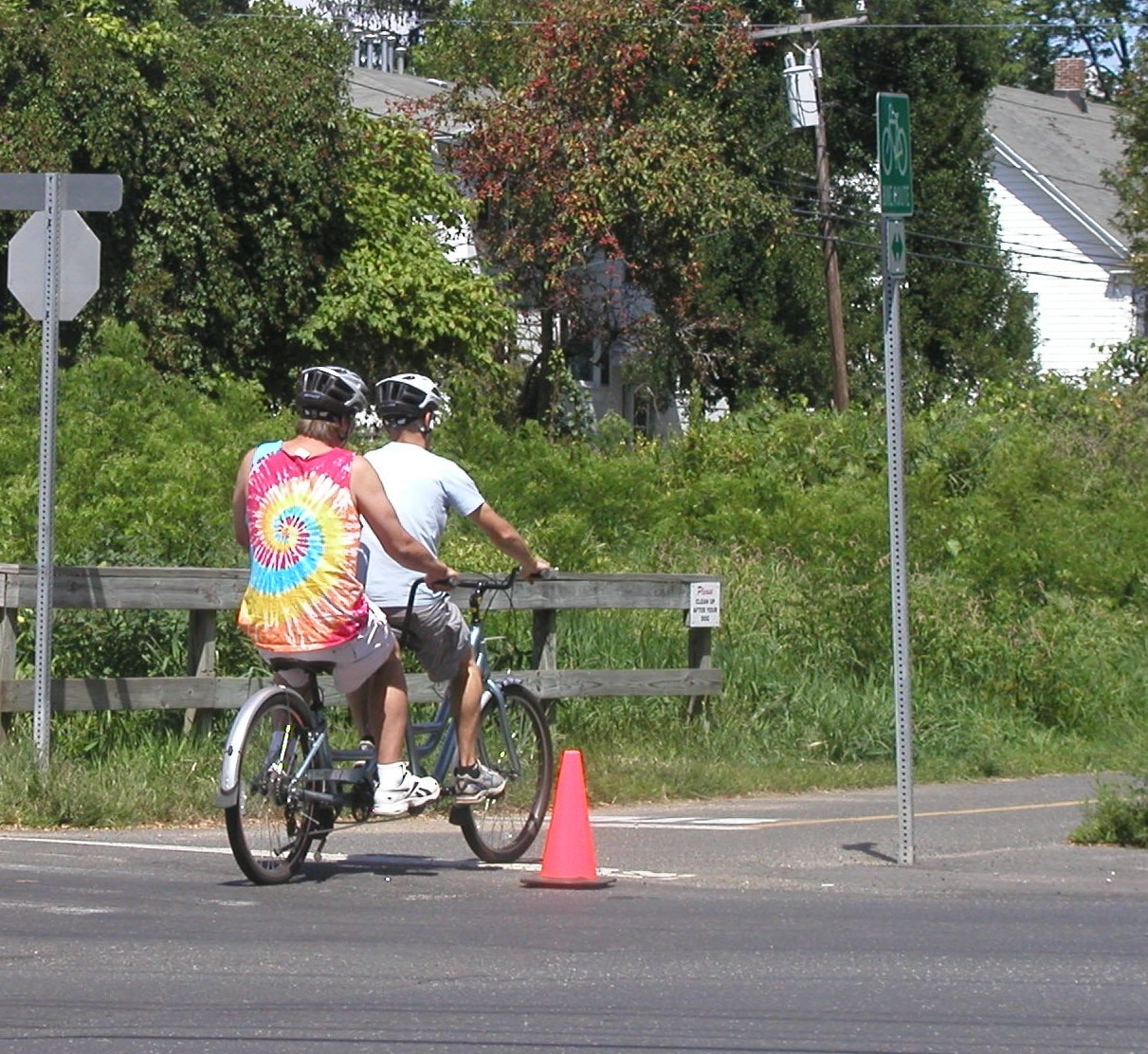 Two riders on a Sun Bicycles Brickell Tandem Bike on a rail trial.