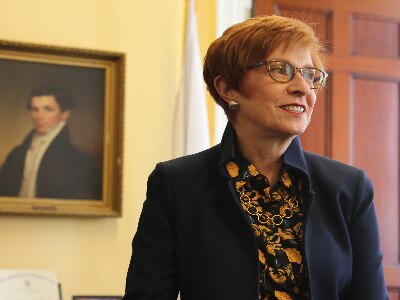 An image of Auditor Bump standing in her State House office.