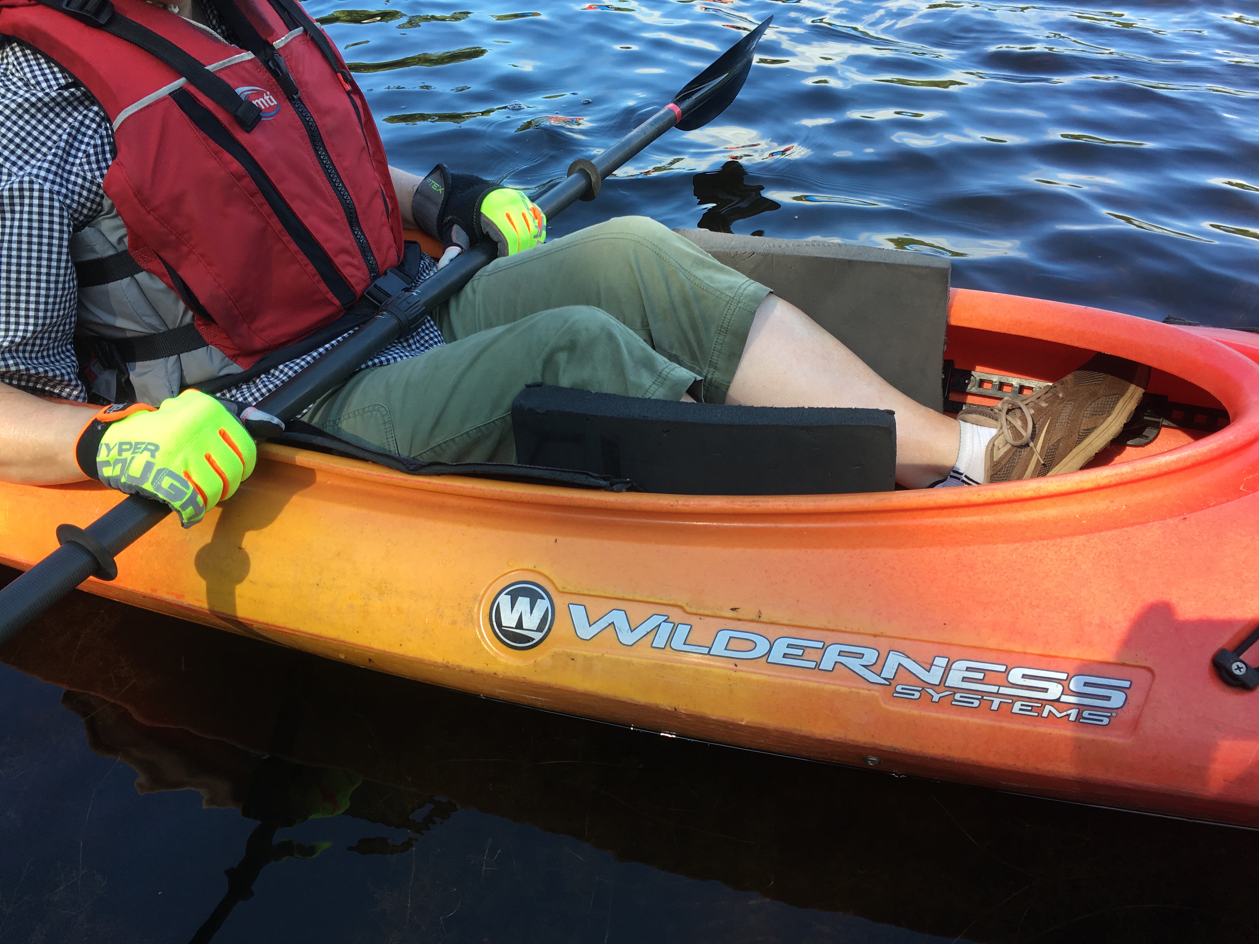 Foam wedges are inserted next to the hull of a kayak, etween the paddlers calves and the boat.