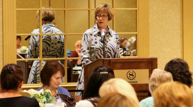 Auditor Bump stands at the podium delivering remarks during the Massachusetts Town Clerks' Association Fall Conference