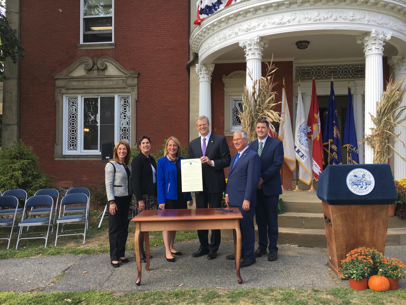 Governor Baker and Lt. Governor Polito with local legislators and officials after signing the 300th Community Compact.