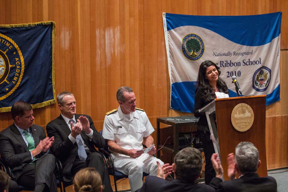 With Rear Admiral Francis McDonald, Governor Charlie Baker, and Mayor Marty Walsh listening, Karina Pena-Seda tells her story about attending Roxbury’s John D. O’Bryant School of Mathematics and Science and then graduating from Massachusetts Maritime Academy.