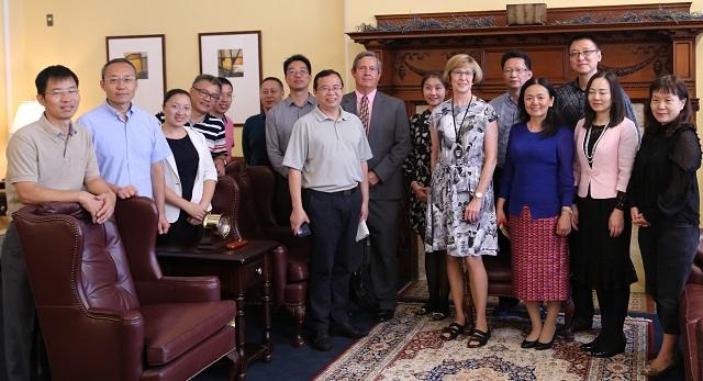 Auditor Bump stands with the group senior auditors from the Audit Bureau of Shenzhen, China in her State House office