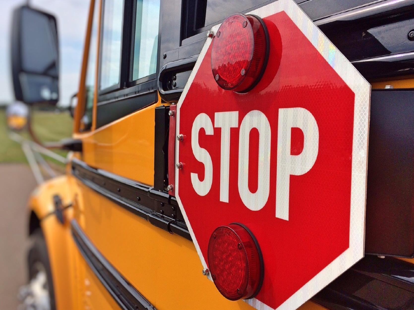 The stop sign on the side of a school bus.