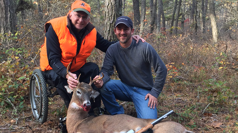Paraplegic deer hunter with MassWildlife staff and deer