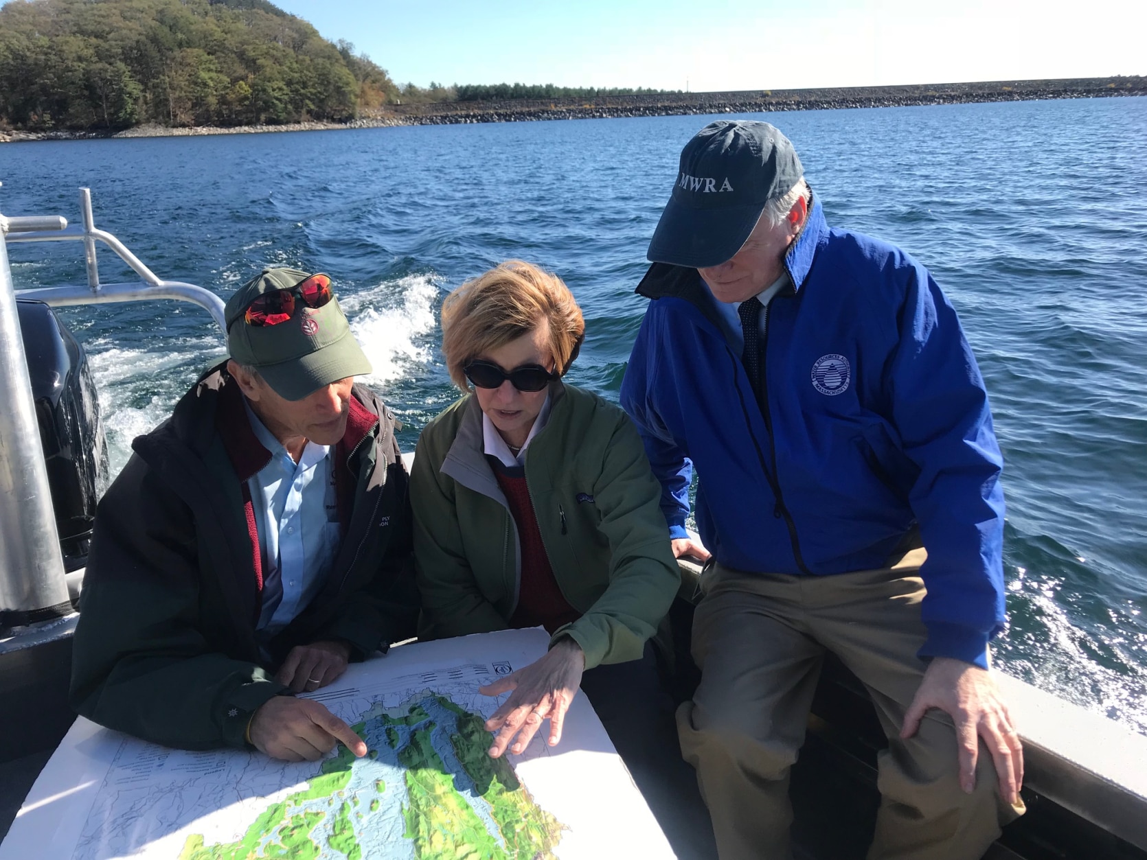 State Auditor Suzanne M. Bump (center) on a boat tour of the Quabbin Reservoir with Fred Laskey (right), Executive Director of the Massachusetts Water Resources Authority and Clif Read (left) of the Massachusetts Department of Conservation and Recreation.