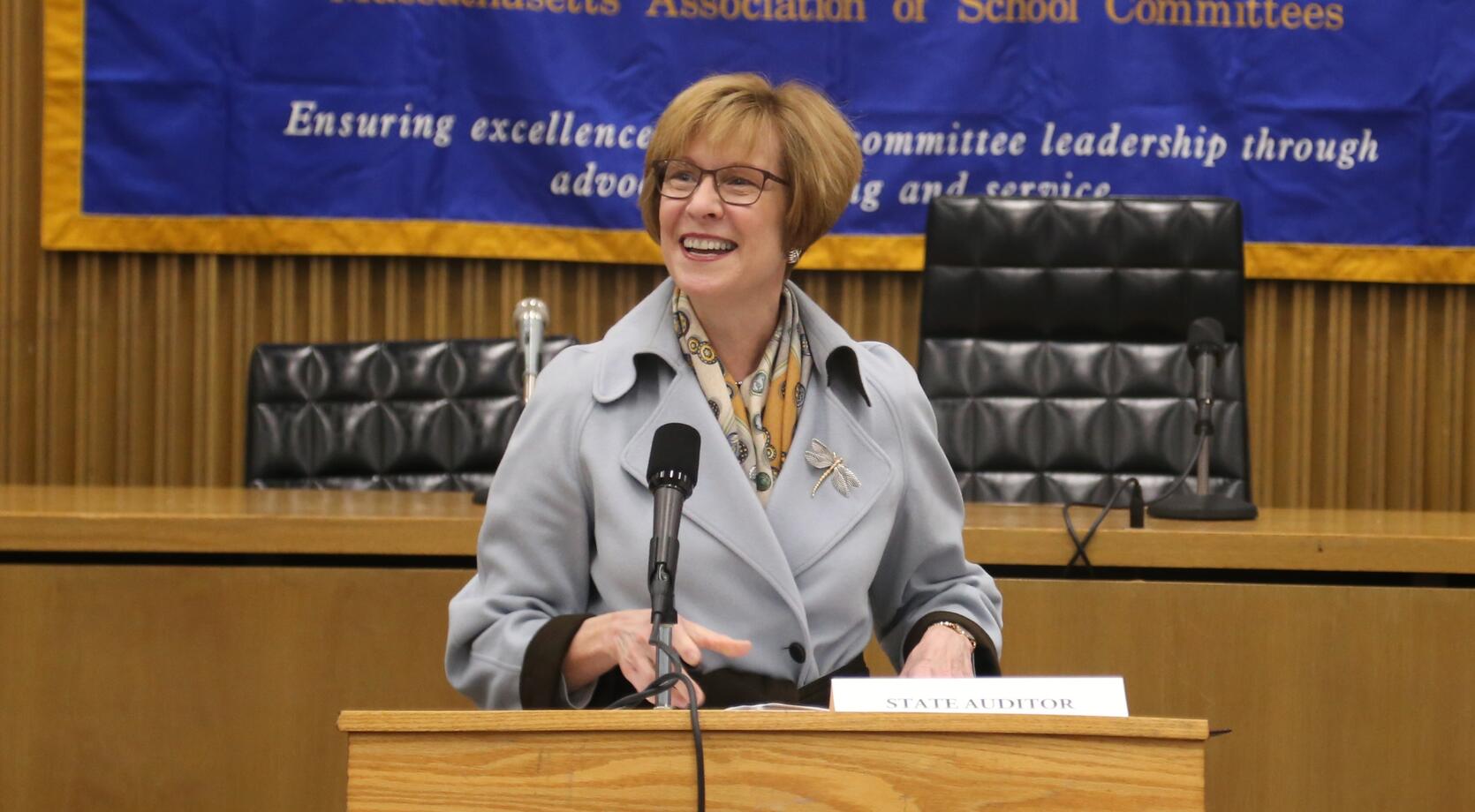 Auditor Bump standing behind a podium