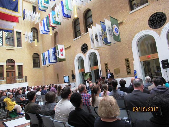 photo of large crowd seated at previous summit, Great Hall of Massachusetts State House