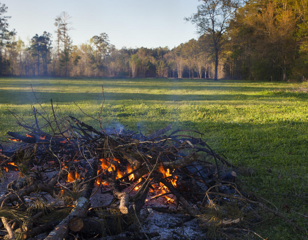 Photo of brush pile burning in a field