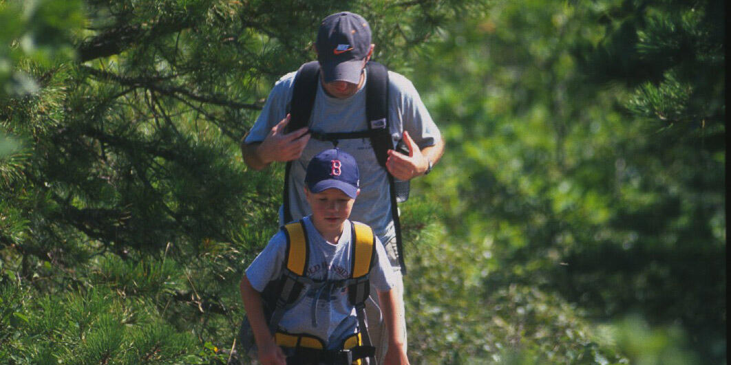 man and boy hiking at blue hills