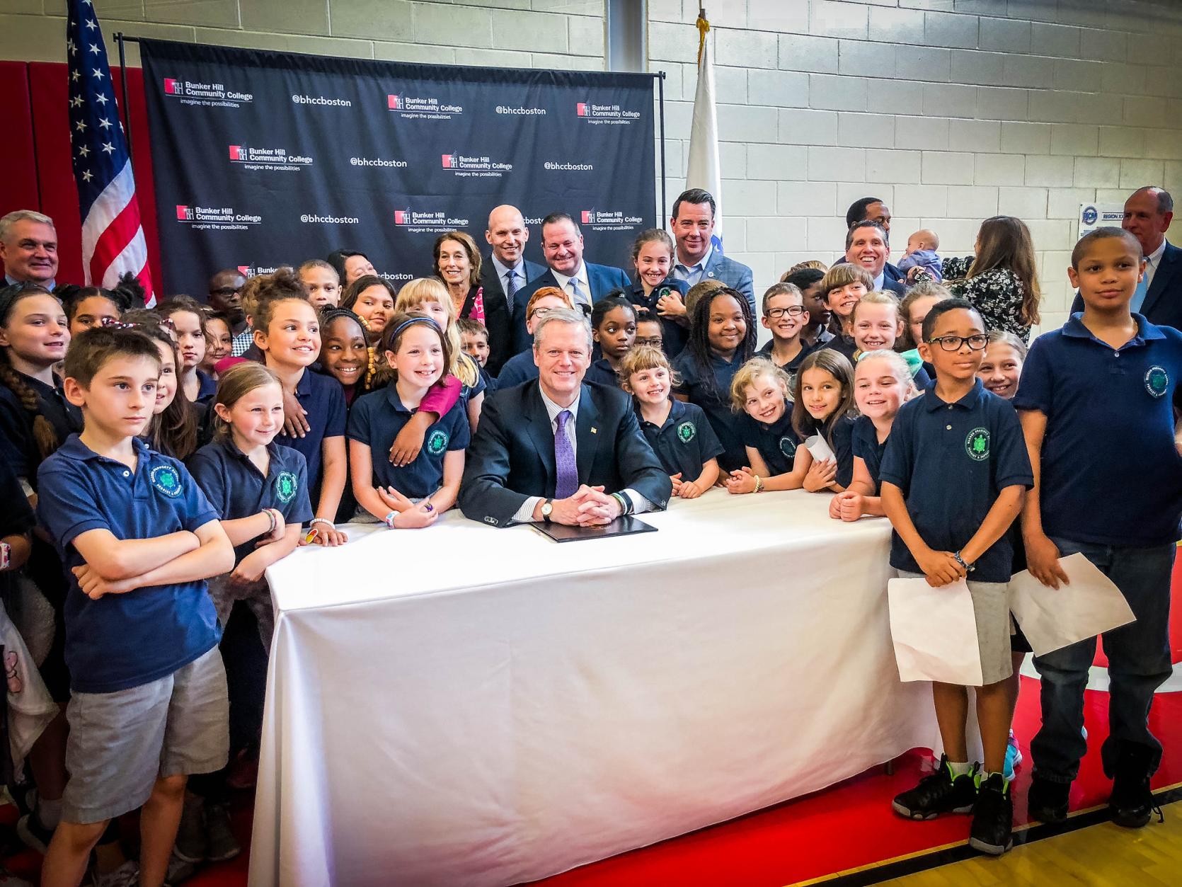 Governor Baker with students at the Life Sciences bill signing.