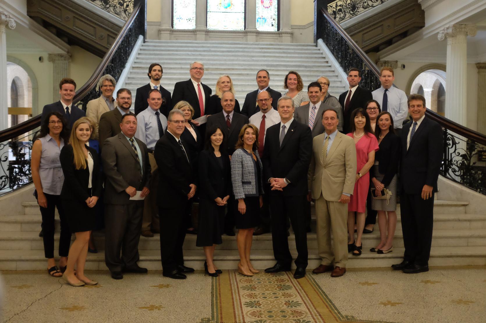 Governor Charlie Baker and Lt. Governor Karyn Polito, center, and EOHED Secretary Jay Ash, right, are joined by officials from Massachusetts cities and towns during the 2018 Community Development Block Grant announcement at the State House.