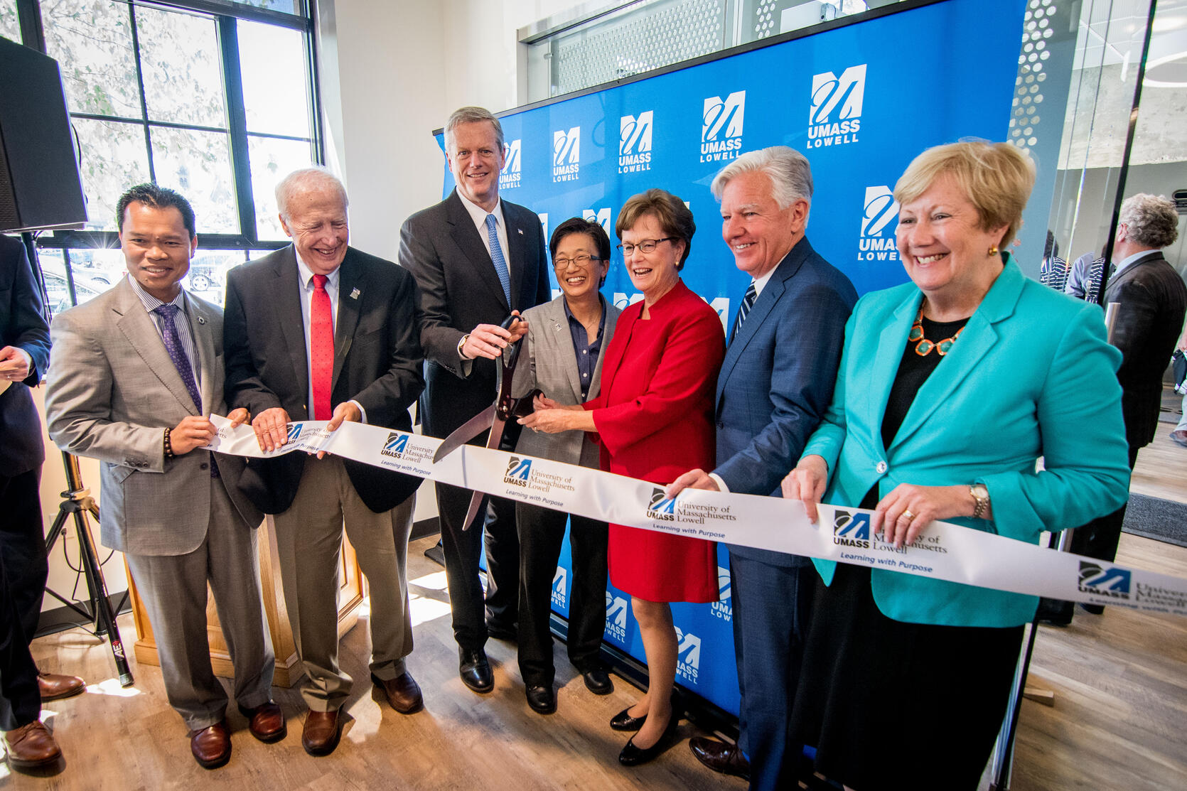 Governor Baker and UMass President Marty Meehan cut ribbon at the Fabric Discovery Center in Lowell