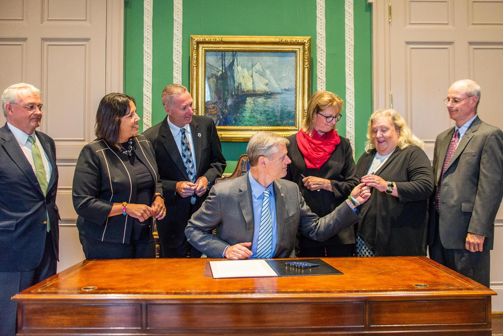 Governor Baker with officials from Salem signs legislation to sell the land that contains the Salem Superior Courthouse building and the County Commissioners building to the Salem Redevelopment Authority.