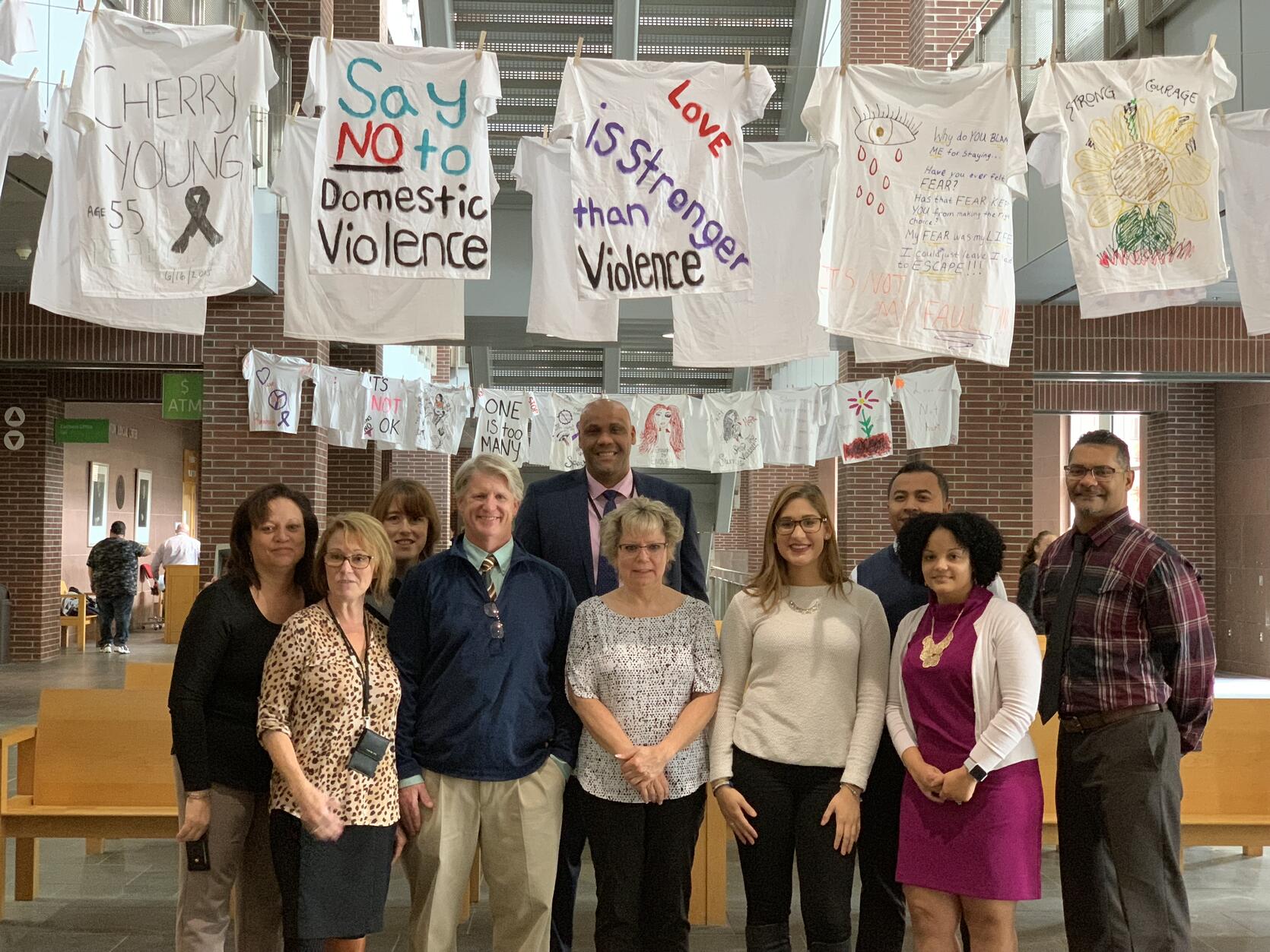 Lawrence District Court Probation Staff in front of their Domestic Violence Awareness Exhibit