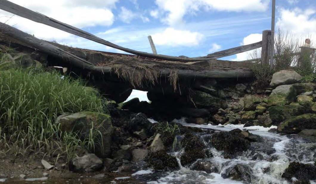 The bridge at Kent’s Island Creek has deteriorated and restricts tidal flow.