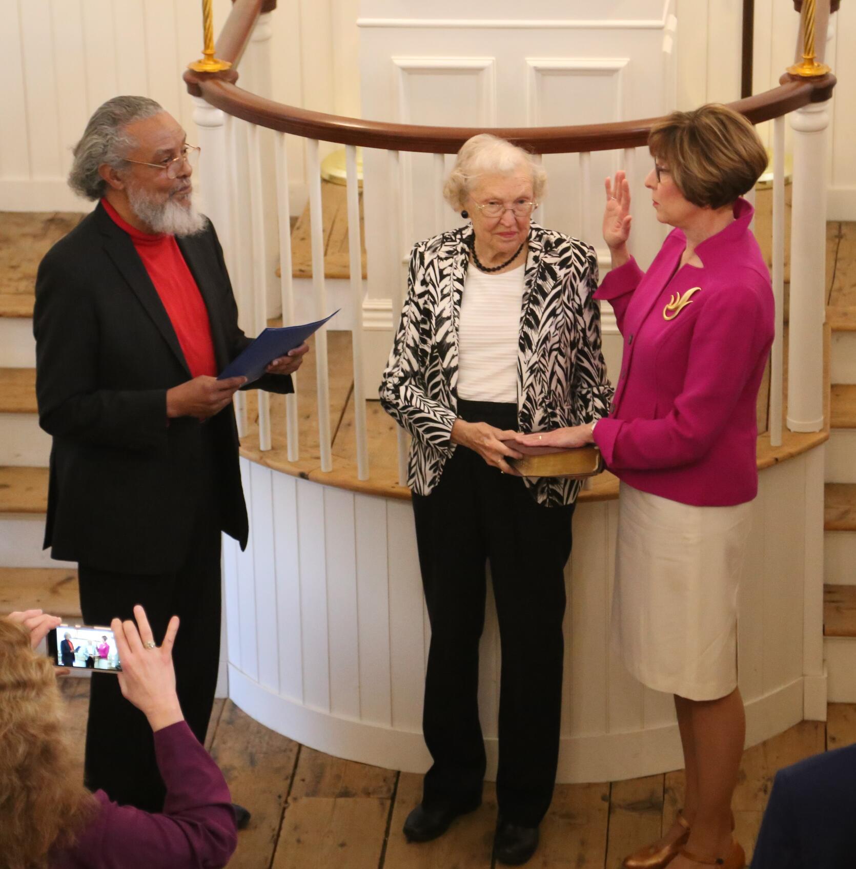 Auditor Bump taking the oath of office, which was administered by Rep. Byron Rushing, as her mother watches on. 