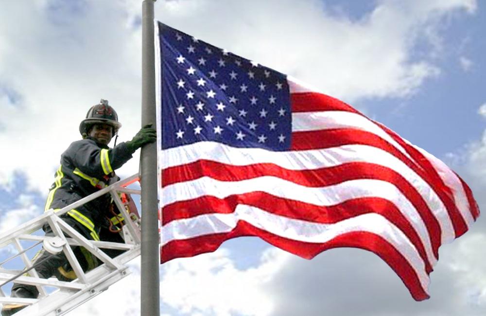 firefighter standing next to stars and stripes