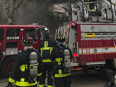 Boston firefighters next to firetruck