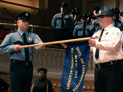 correction officers holding the DOC flag