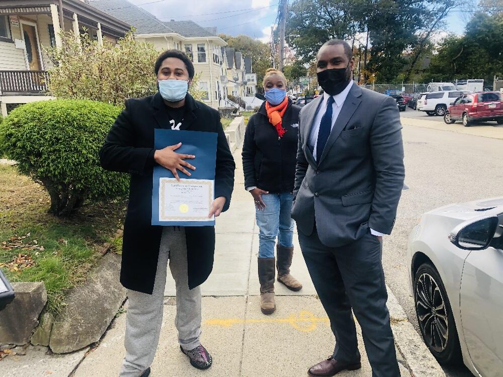 Probation Officer Edith Alexander with Evolution Graduate Brandon Smith showing his certificate.