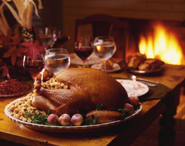 Thanksgiving turkey on table, fire in fireplace with screen in background
