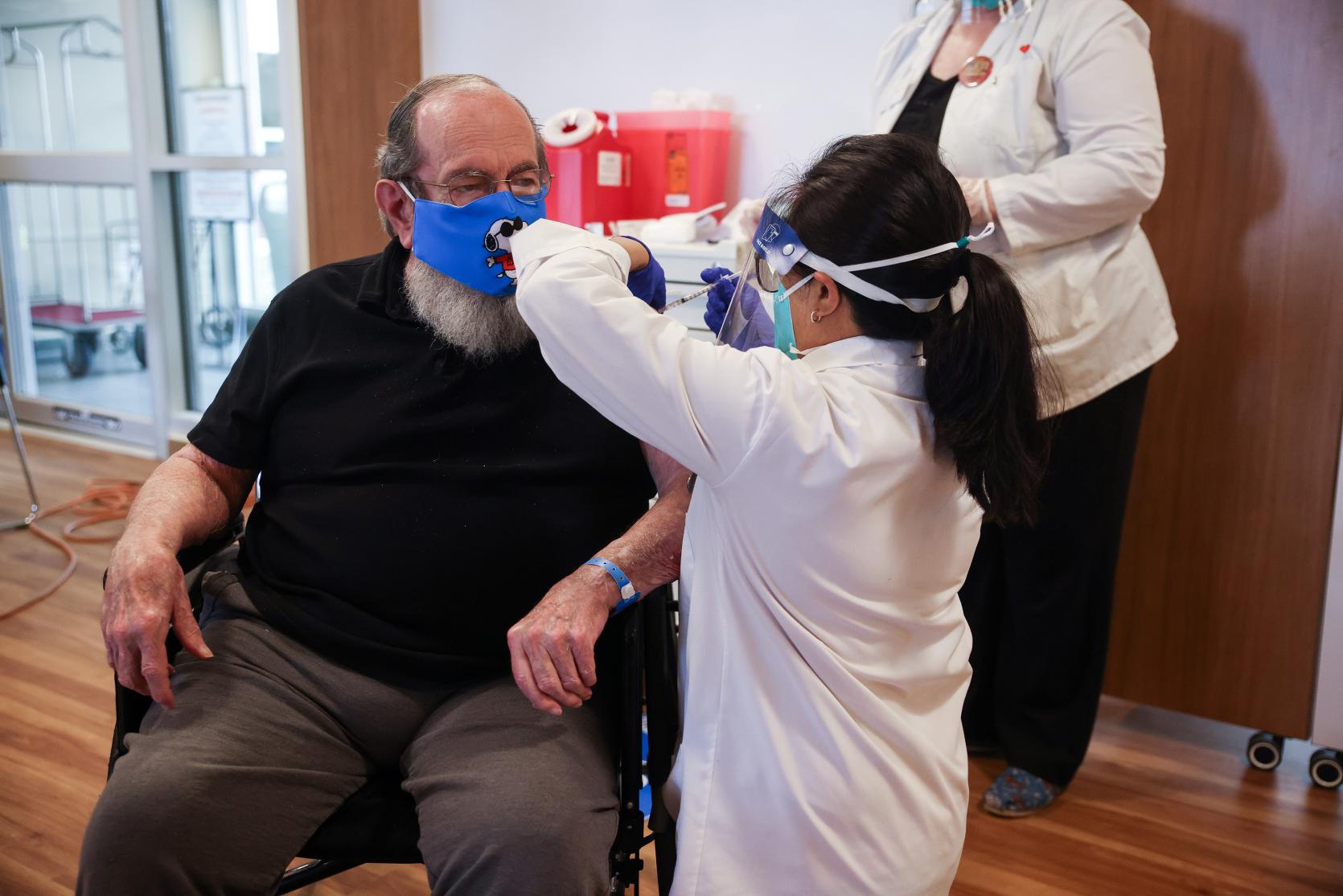 Robert Aucoin, 78, a U.S. Air Force veteran and resident at the Soldiers’ Home in Holyoke, receiving the first COVID-19 vaccine at the Home. Photo credit: Leon Nguyen/The Springfield Republican