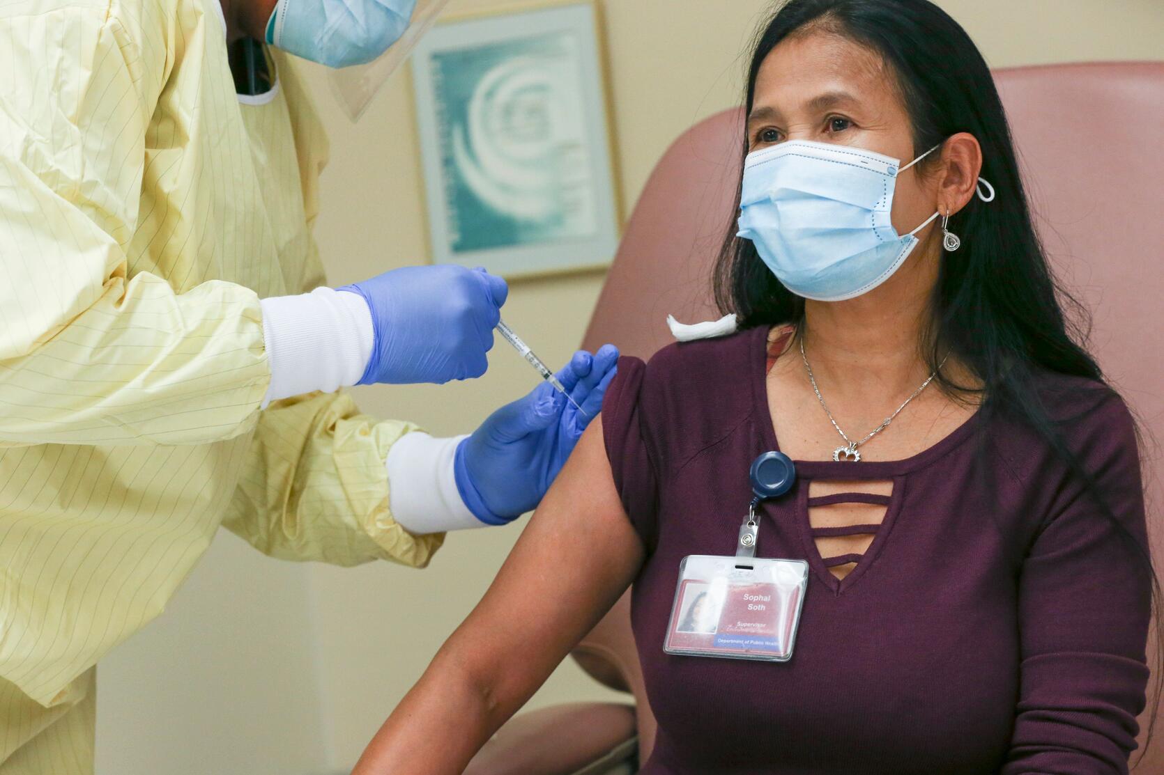 Sophal “Paula” Soth receiving the first vaccination for a Massachusetts state employee