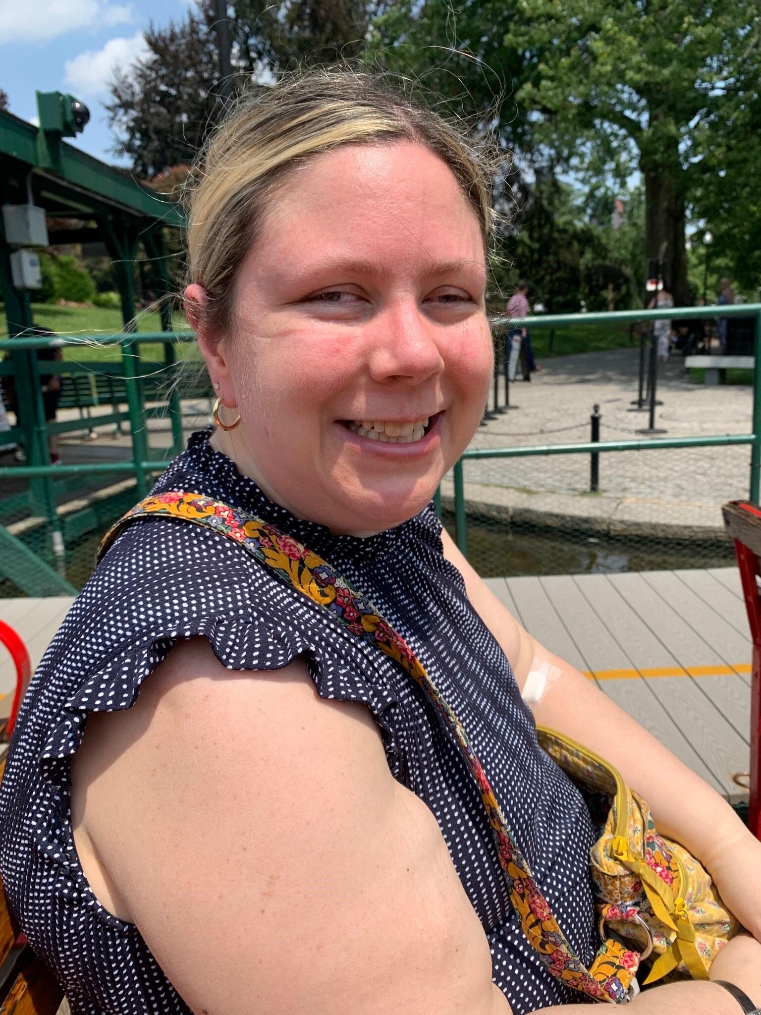 Emily Dussault sitting outdoors in a swan boat the Boston Public Garden