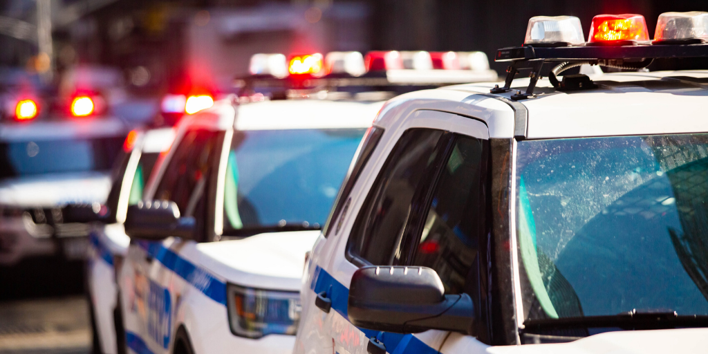 Image of police cruisers with lights flashing