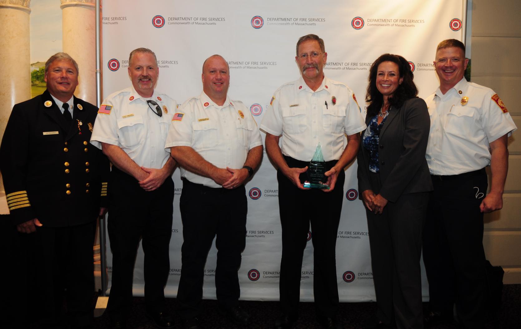 Captain James Brooks receiving an award with fire officials