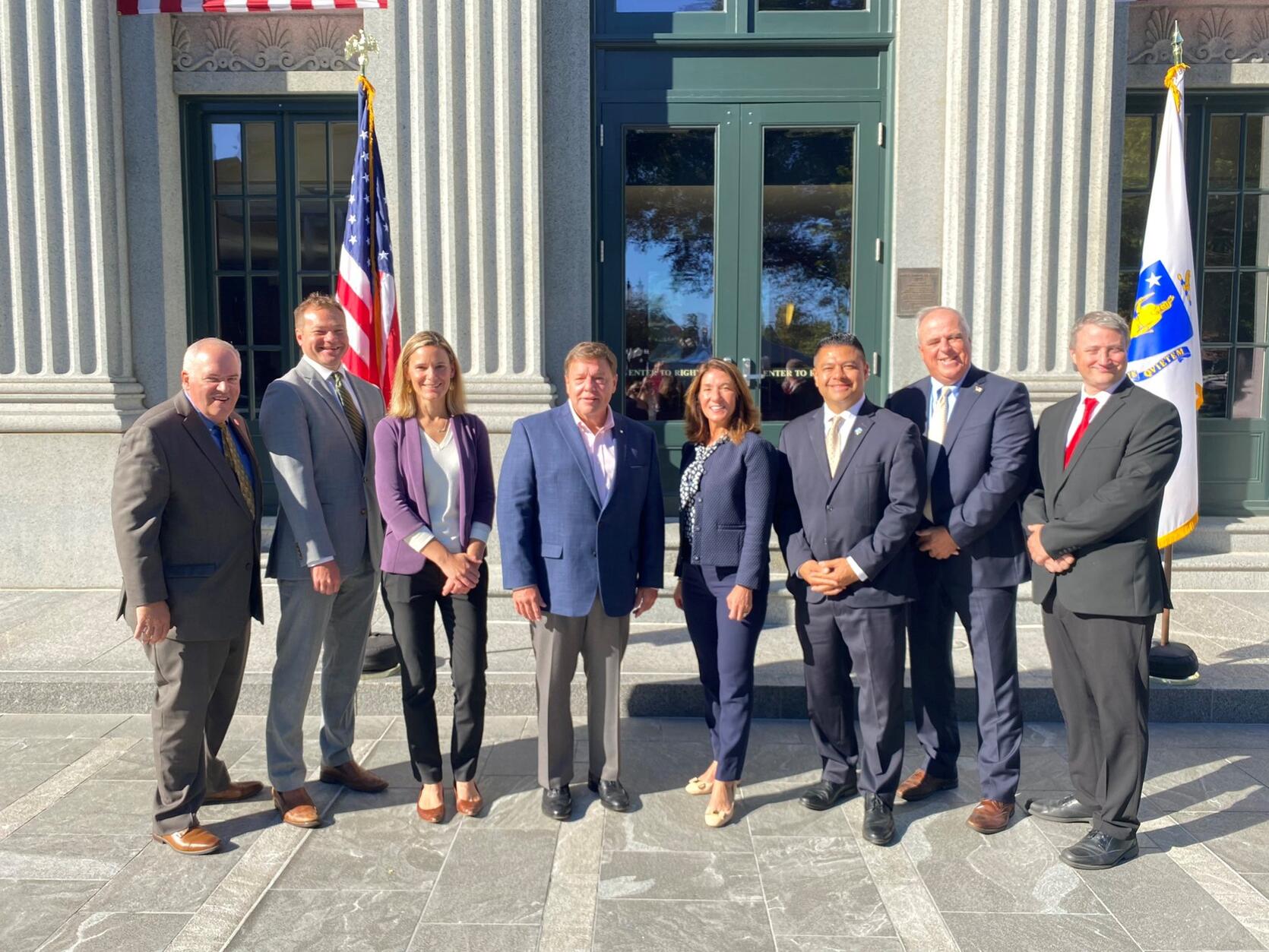 Quincy City Councilor Charles Phelan, Department of Energy Resources Commissioner Patrick Woodcock, Executive Office of Energy and Environmental Affairs Secretary Kathleen Theoharides, Quincy Mayor Thomas Koch, Lieutenant Governor Karyn Polito, Quincy City Councilor Noel DiBona, Quincy City Councilor David McCarthy, and Quincy City Councilor Brian Palmucci all joined at Old City Hall in Quincy.