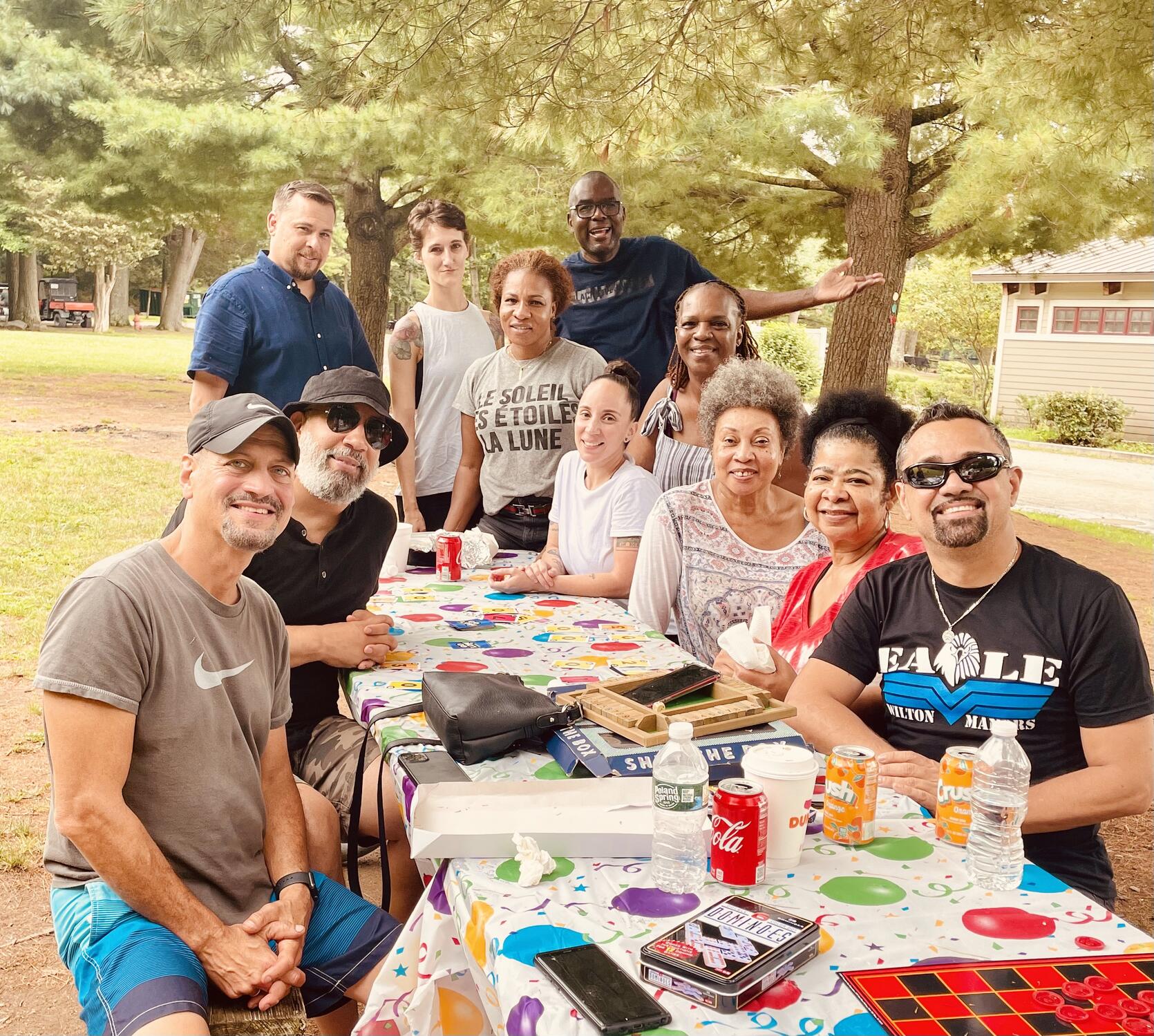 a group of diverse people at picnic table