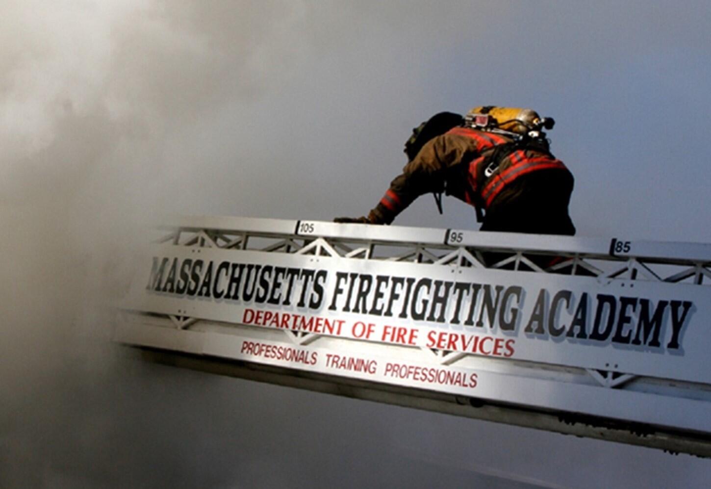 Firefighter climbing a ladder