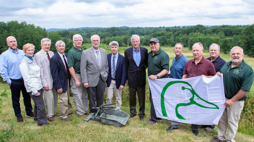 Fisheries and Wildlife Board Members, MassWildlife staff, Ducks Unlimited Members smile with tub net launcher