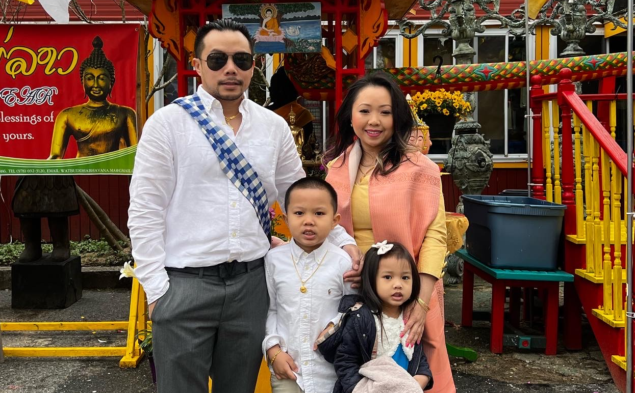 an Asian family of four poses for a photo