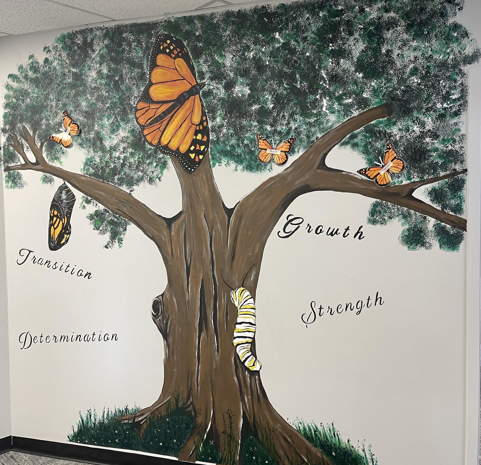 A growth tree mural at the Taunton Community Justice Support Center