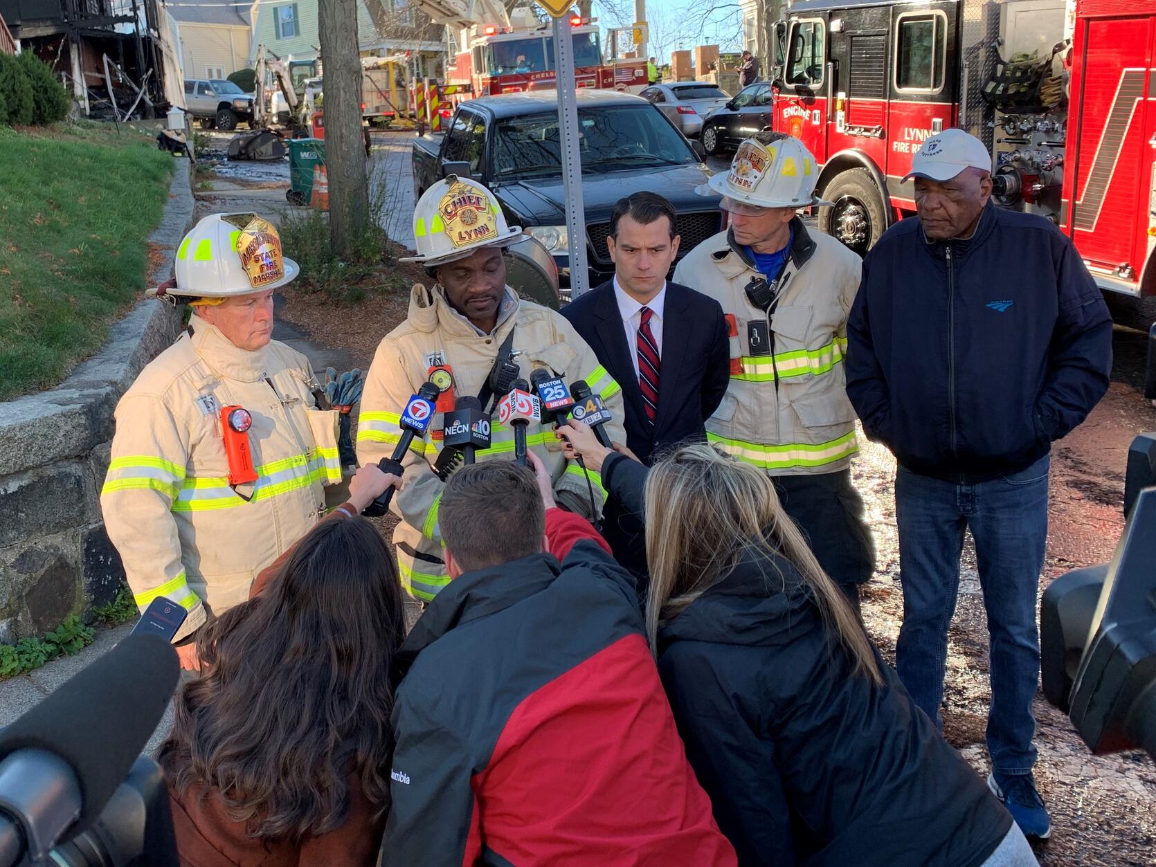 Photo of firefighters speaking to reporters