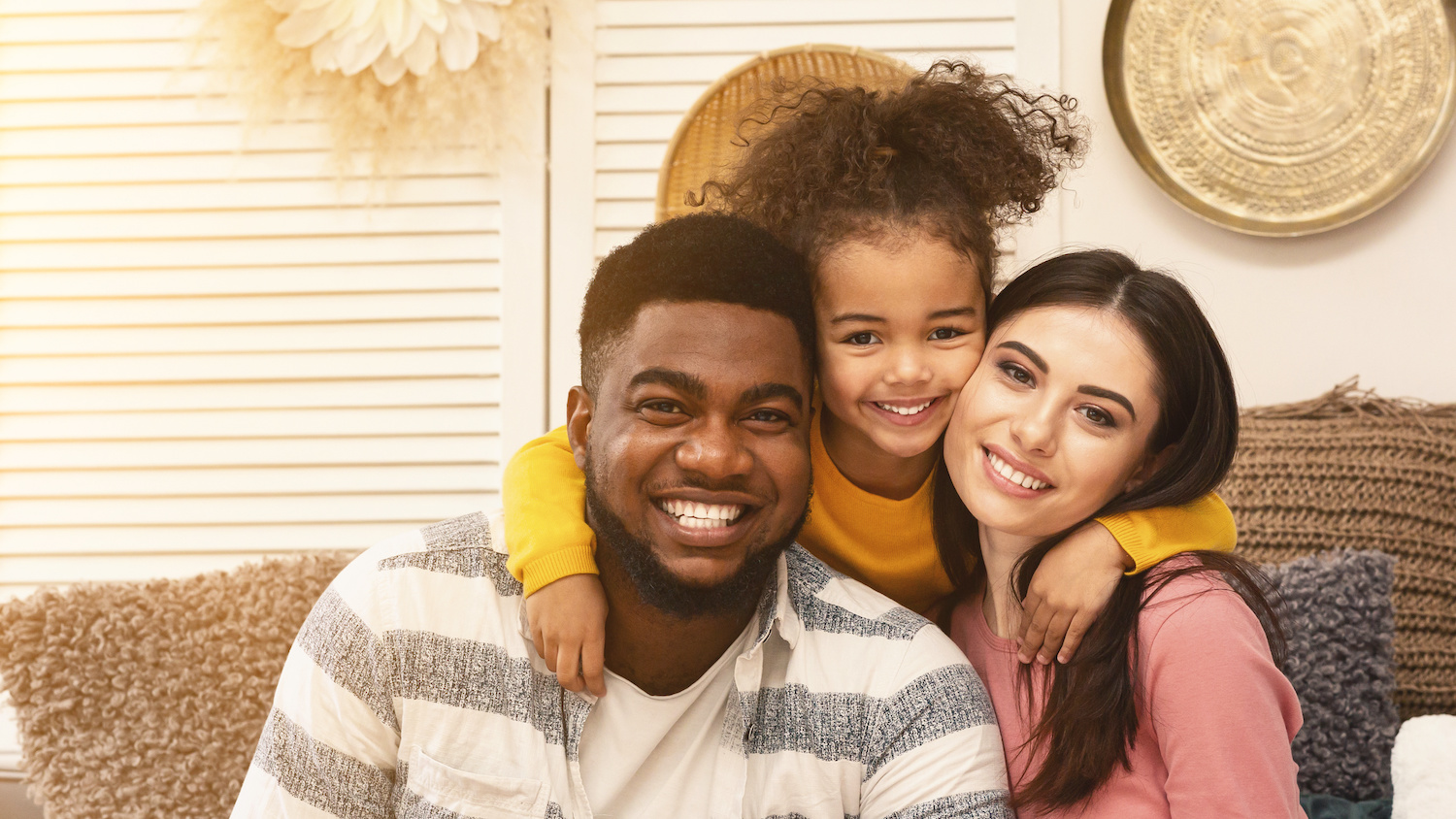 A family huddled together smiling 